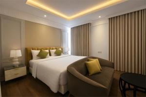 a bedroom with a large bed and a couch at Maia Hotel Jakarta in Jakarta +79 photos