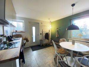 a kitchen and dining room with a table and a table and chairs at AHOI MARIE in Blekendorf