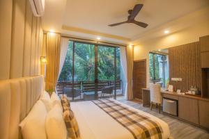 a hotel room with a bed and a large window at Amera Hiriketiya in Dickwella