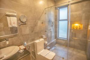 a bathroom with a shower and a toilet and a sink at Amera Hiriketiya in Dickwella +43 photos