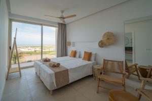 a bedroom with a bed and a view of the ocean at Villa Gypsy by Aura Collection in Tindaya