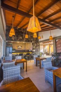 a dining room with tables and chairs and lights at Amera Hiriketiya in Dickwella