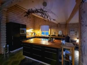 a kitchen with a wooden counter top in a room at Round Timber House In Forest Near Mariager in Hadsund