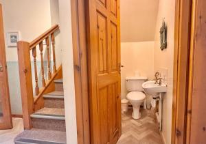 a bathroom with a toilet and a sink at Seacrest Cottage in Conwy