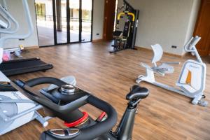 a gym with a treadmill and a exercise bike at Bella Vida Resort, Uluwatu in Uluwatu