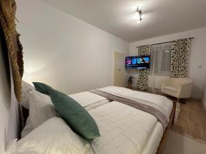 a bedroom with two beds and a television in it at Central House - Modern Apartment in Zărneşti