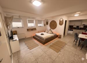 a large bedroom with a bed and a kitchen at BOHO Apartment Auréa nähe Salzburg in Freilassing +8 photos