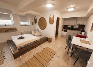 a large room with a bed and a kitchen at BOHO Apartment Auréa nähe Salzburg in Freilassing