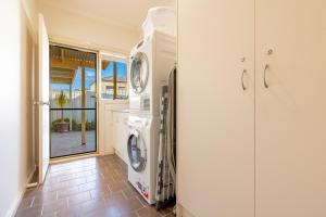 a laundry room with a washer and dryer at Comfort & Quiet 3BR, CBD 5mins in Kennington