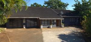 a house with potted plants in front of it at Sthuli House in Empangeni