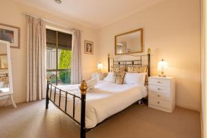a bedroom with a large bed and a window at Comfort & Quiet 3BR, CBD 5mins in Kennington