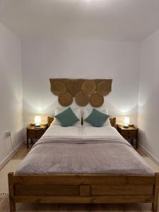 a bedroom with a large bed with two night stands at Central House - Modern Apartment in Zărneşti