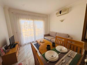 a living room with a dining room table and a couch at Sea simple haven in Sharm El Sheikh