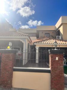 a house with a gate in front of it at El descanso in Higuey +6 photos