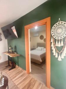 a room with a bedroom with a bed and a mirror at El descanso in Higuey