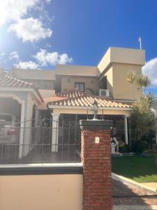a house with a gate and a brick pillar at El descanso in Higuey