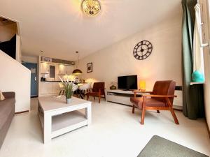 a living room with a couch and a table at Amelander Kaap 109 in Hollum
