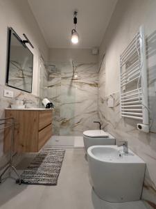 a bathroom with a tub and a sink and a toilet at Brugnoli 13 Guest House in Bologna