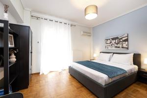 a bedroom with a bed and a large window at Houseloft CityView Hagia Sophia in Thessaloniki