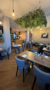 a restaurant with tables and chairs in a room at The courtyard bar, kitchen, rooms in Falkirk