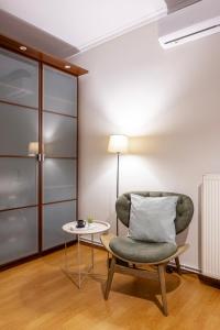 a living room with a chair and a table at Houseloft CityView Hagia Sophia in Thessaloniki +36 photos