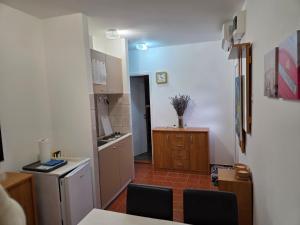 a room with a kitchen with a table and chairs at Villa Bianca in Baška