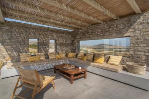 a living room with a couch and a table at Villa Anelya in Parikia