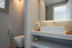 a bathroom with a sink and a toilet and a mirror at Villa Anelya in Parikia +177 photos