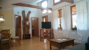 a living room with a tv and a table at Biohof - Familie Neuberger in Pöttelsdorf
