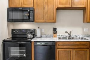 a kitchen with a black stove and a sink at Bird House Pet-Friendly Studio, near Dollywood in Pigeon Forge