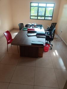 a conference room with a large table and chairs at Hacienda Villa in Juja