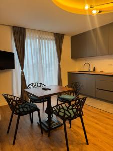 a kitchen with a table and chairs in a room at Pansion Afitos in Laktaši