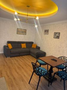a living room with a couch and a table and chairs at Pansion Afitos in Laktaši +14 photos