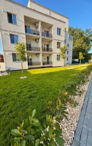 an apartment building with a green lawn in front of it at Studio Noa Escape in Saturn