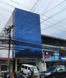 a blue building with cars parked in front of it at Rafael Suites Inn in Mojon