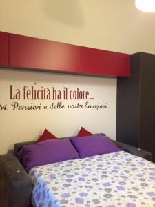 a bedroom with a bed with a sign on the wall at Cosy Studio Historical Center in Cremona