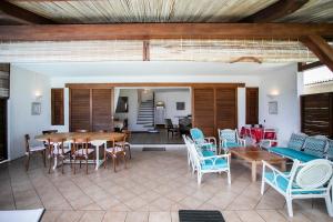a living room with a table and chairs at Beach, Blue Sea, Sunset and Private Pool in Rivière Noire
