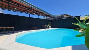 a swimming pool in the backyard of a house at Mango Coliving Rooms for Digital Nomads in Uvita