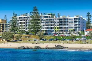 a view of a beach with a large building at Sandcastle Apartments in Port Macquarie