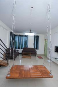a living room with a swing in the middle at Swara Villa Your Perfect Getaway in Jāmb