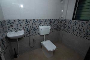 a bathroom with a toilet and a sink at Swara Villa Your Perfect Getaway in Jāmb +43 photos