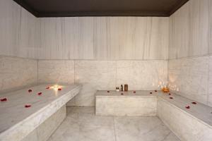 a white bathroom with two tubs and candles in it at Park Suites Hotel Luxury Boutique Hotel in Casablanca +21 photos