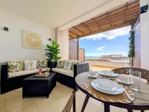 a living room with a table and chairs and a couch at Beautiful Apartment overlooking Samaná Bay in Cayo Vigía