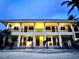 a large building with palm trees in front of it at Lavajas Guest House in San Juan