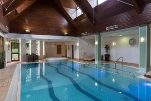 a large swimming pool in a large building at Oakley Court in Windsor