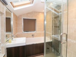 a bathroom with a sink and a shower at Kirkham House in Matlock +34 photos