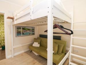 a bed in a loft bedded room with a couch at Kirkham House in Matlock