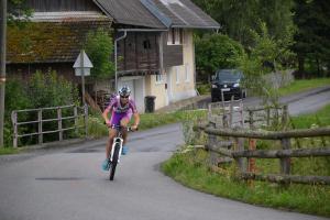 a person riding a bike down a road at Ferienhaus Riegler in Sankt Georgen bei Neumarkt
