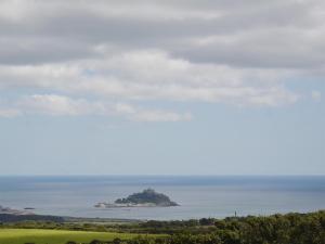 an island in the ocean in the distance at Heather Brae Lodge in Nancledra