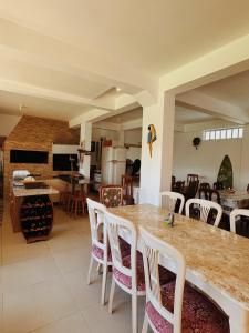 a kitchen and living room with a table and chairs at Residencial Marilis in Palhoça
